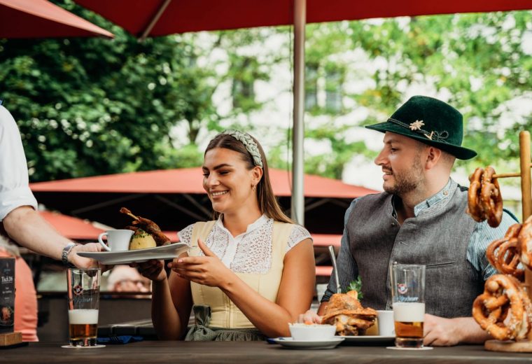 Essen im wirtshaus der pschorr münchen genießt regionale bayerische spezialitäten – frau bekommt eine ente mit knödel, mann hat haxe mit knödel und kraut. Reservieren sie ihren tisch im pschorr am viktualienmarkt.